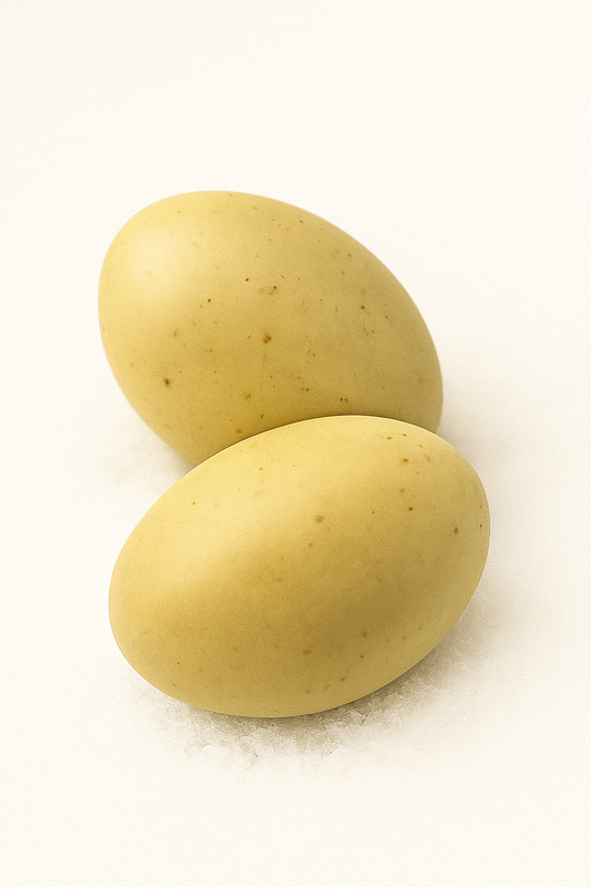 Oval-shaped natural yoni soap resting on a clean white background, representing gentle, hydrating, and soothing care for delicate feminine skin.